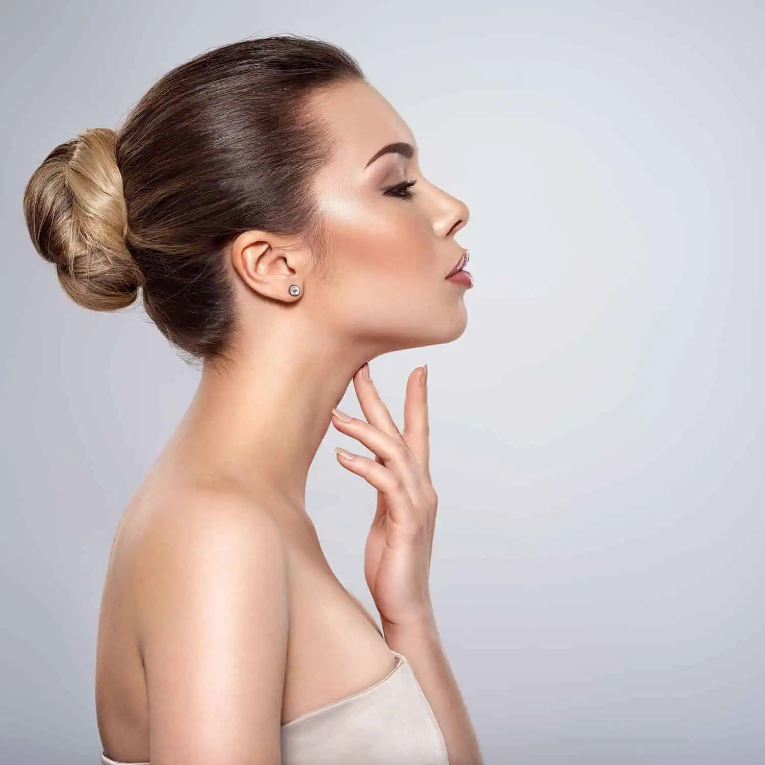 A young woman touching her chin in Beverly Hills, CA | Maven Medispa